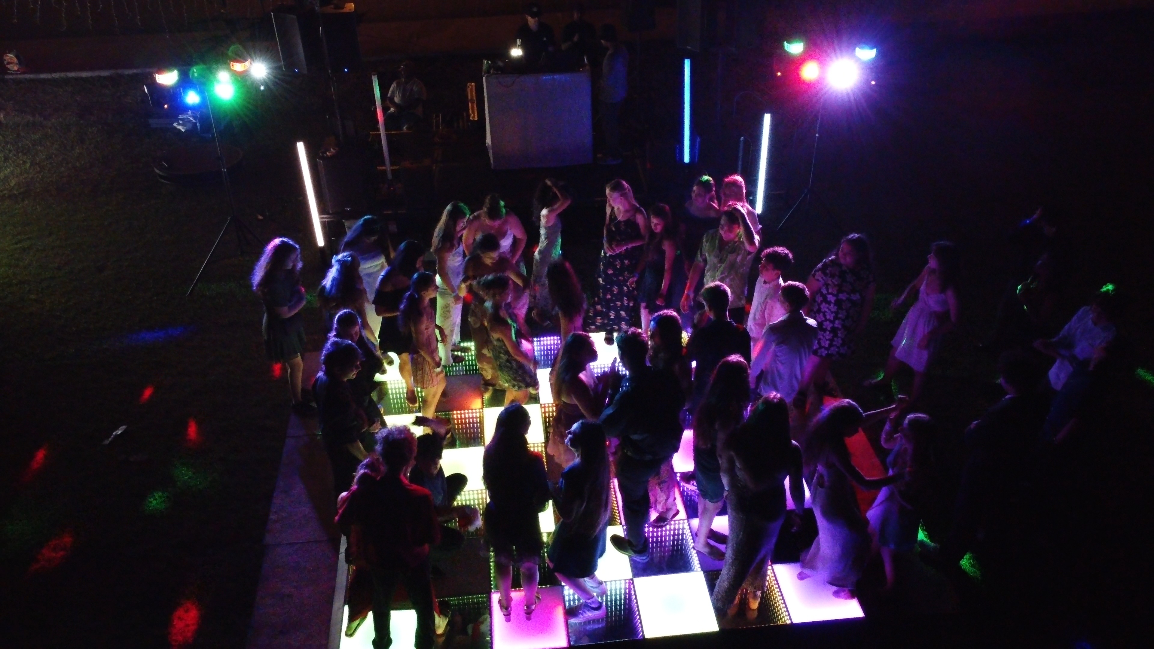 Illuminated dance floor with guests